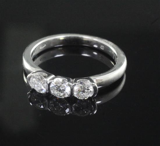 A modern Theo Fennell 18ct white gold and three stone diamond ring, size J.